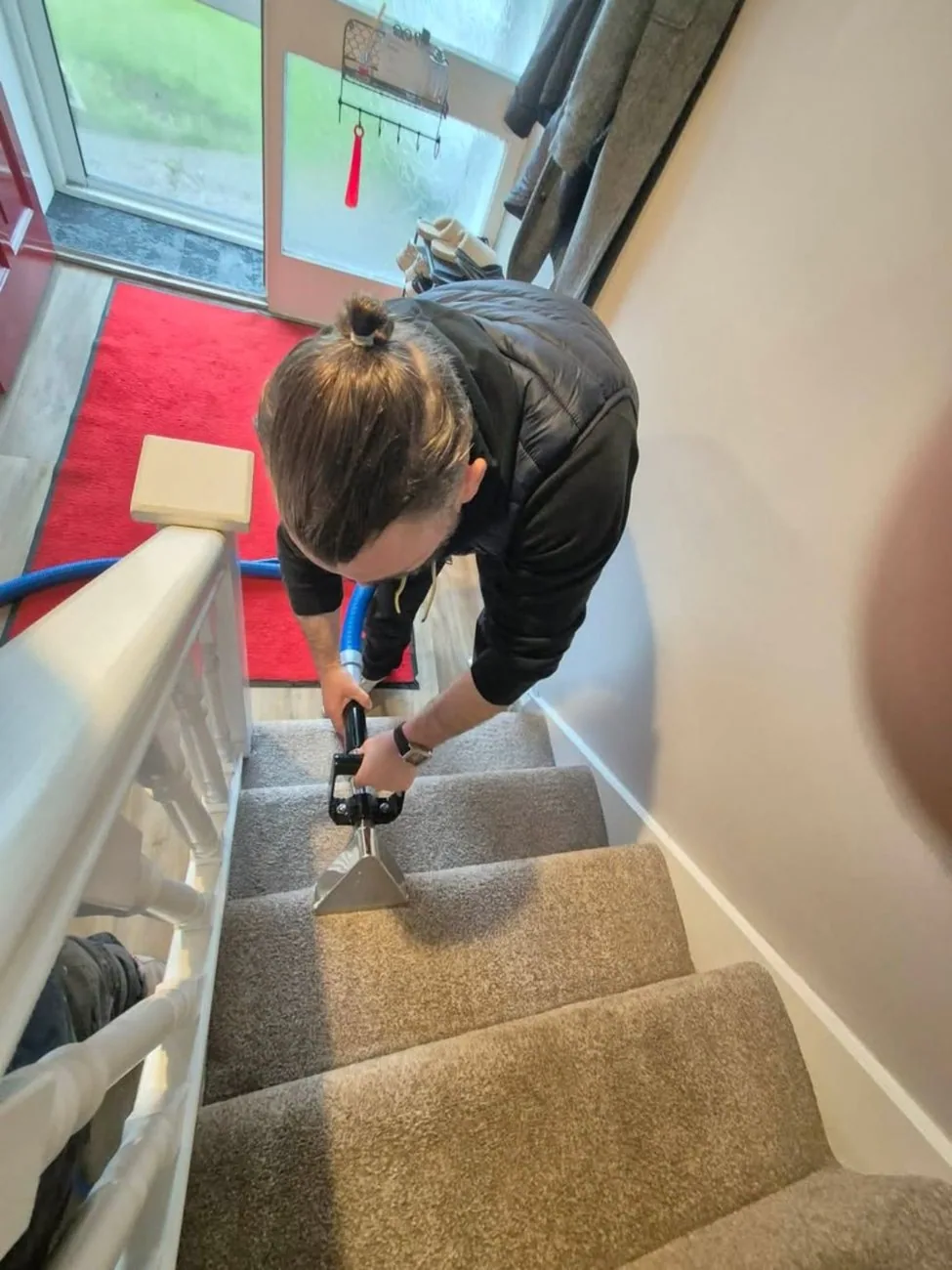 Carpeted stairs being cleaned